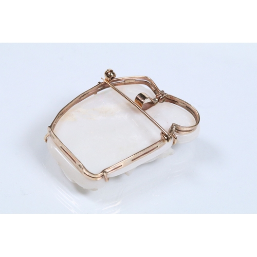 26 - 20th Century carved opal cameo brooch featuring a left facing female portrait set within a 9ct gold ... 