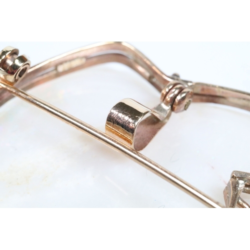 26 - 20th Century carved opal cameo brooch featuring a left facing female portrait set within a 9ct gold ... 