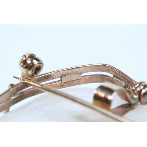 26 - 20th Century carved opal cameo brooch featuring a left facing female portrait set within a 9ct gold ... 