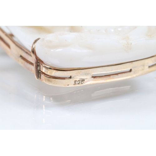 26 - 20th Century carved opal cameo brooch featuring a left facing female portrait set within a 9ct gold ... 