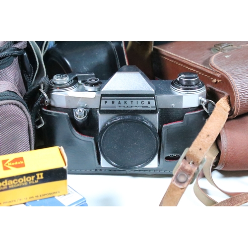 Four cased cameras and accessories to include a folding 'Braun Norca ...