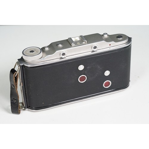 Four cased cameras and accessories to include a folding 'Braun Norca ...