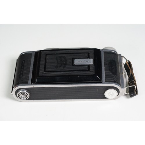 Four cased cameras and accessories to include a folding 'Braun Norca ...