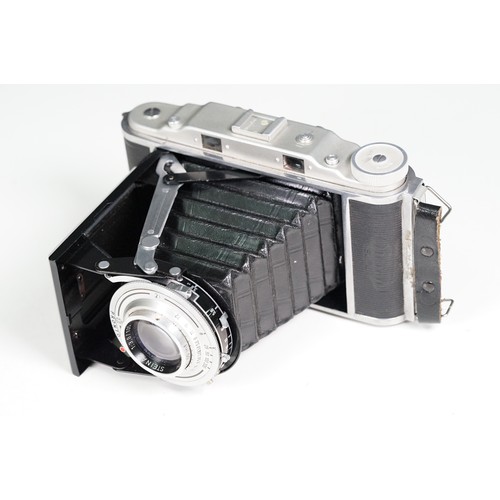 Four cased cameras and accessories to include a folding 'Braun Norca ...