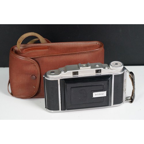 Four cased cameras and accessories to include a folding 'Braun Norca ...
