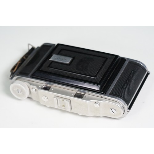 Four cased cameras and accessories to include a folding 'Braun Norca ...