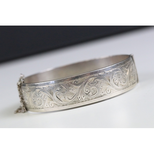 271 - A fully hallmarked solid sterling silver vintage 1960's cuff bangle, engraved decoration to the fron... 