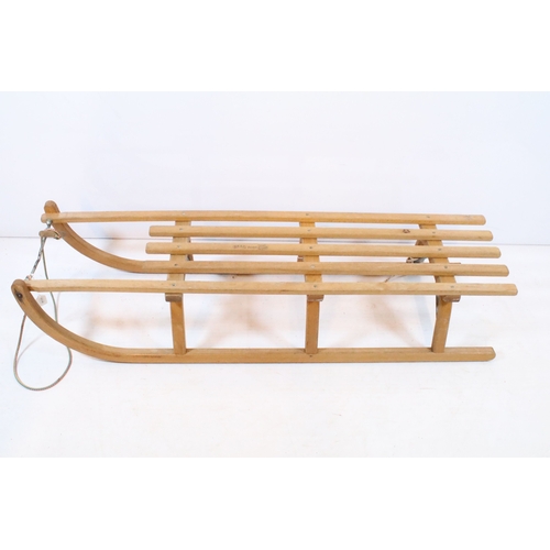 647 - Traditional wooden sleigh by Ress, having slatted top and metal bound tread, L 101cm (approx)