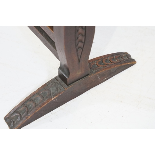 684 - Victorian mahogany framed fire screen, having carved top rail dated 1889 flanked with dogs mask head... 