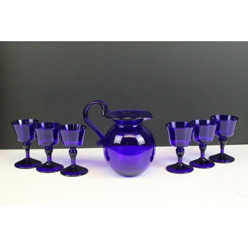 69 - Bristol Blue glass table set, comprising six glasses and a jug, H 15.5cm (7)