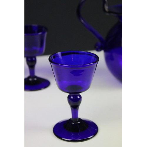 69 - Bristol Blue glass table set, comprising six glasses and a jug, H 15.5cm (7)