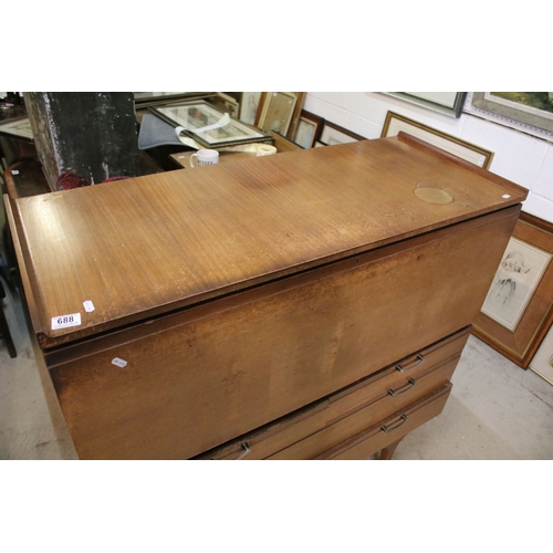 628 - Mid 20th century teak drinks cabinet, having fall front upon three long drawers, raised on square ta... 