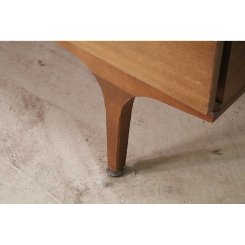 628 - Mid 20th century teak drinks cabinet, having fall front upon three long drawers, raised on square ta... 