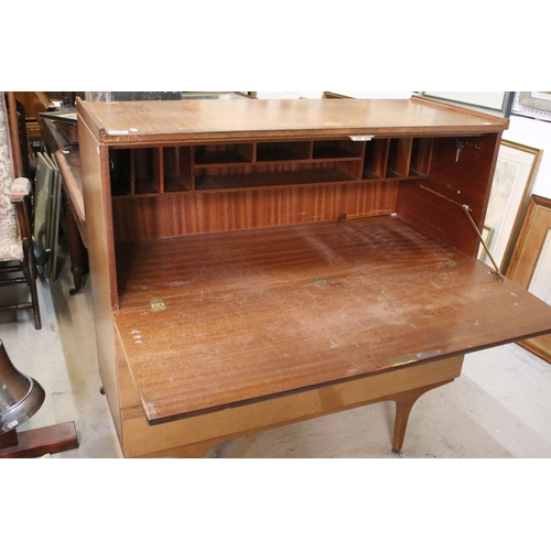 628 - Mid 20th century teak drinks cabinet, having fall front upon three long drawers, raised on square ta... 