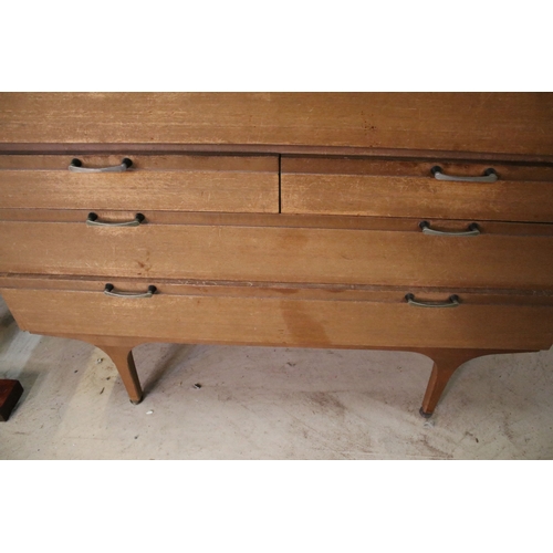 628 - Mid 20th century teak drinks cabinet, having fall front upon three long drawers, raised on square ta... 