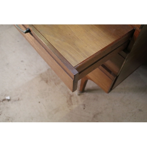 628 - Mid 20th century teak drinks cabinet, having fall front upon three long drawers, raised on square ta... 