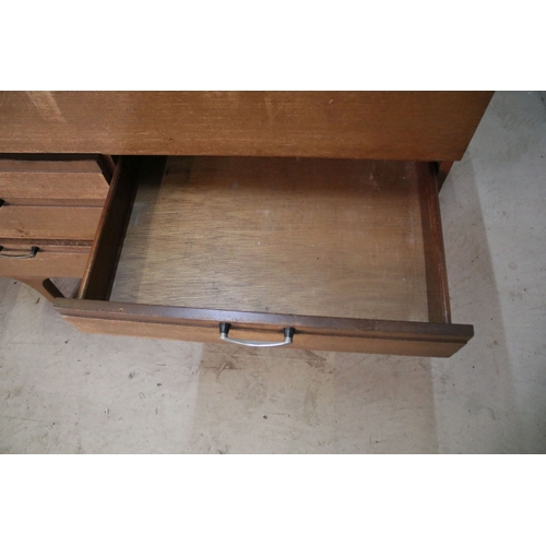 628 - Mid 20th century teak drinks cabinet, having fall front upon three long drawers, raised on square ta... 