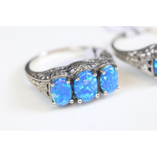 244 - Silver 925 ring with three oval cut blue synthetic opals with filigree surround, together with a sim... 