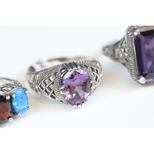 244 - Silver 925 ring with three oval cut blue synthetic opals with filigree surround, together with a sim... 