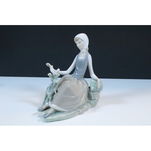 27 - Group of six Lladro and a Nao porcelain figurines to include rabbit, girl and dog, polar bear, cat, ... 