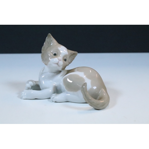 27 - Group of six Lladro and a Nao porcelain figurines to include rabbit, girl and dog, polar bear, cat, ... 