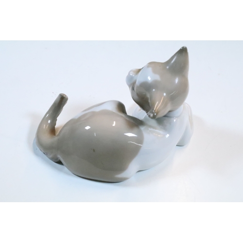 27 - Group of six Lladro and a Nao porcelain figurines to include rabbit, girl and dog, polar bear, cat, ... 