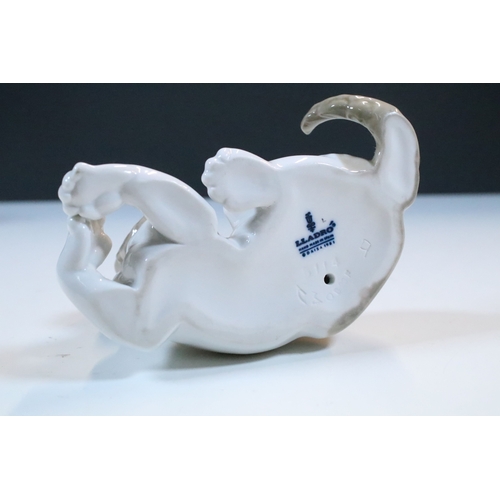 27 - Group of six Lladro and a Nao porcelain figurines to include rabbit, girl and dog, polar bear, cat, ... 