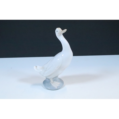 27 - Group of six Lladro and a Nao porcelain figurines to include rabbit, girl and dog, polar bear, cat, ... 