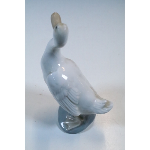 27 - Group of six Lladro and a Nao porcelain figurines to include rabbit, girl and dog, polar bear, cat, ... 