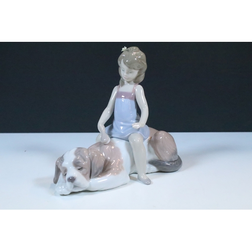 27 - Group of six Lladro and a Nao porcelain figurines to include rabbit, girl and dog, polar bear, cat, ... 
