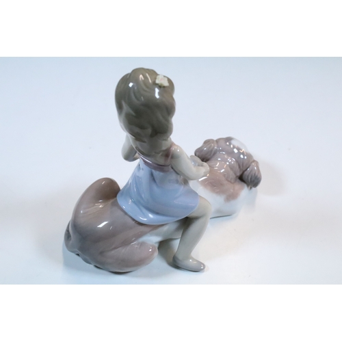 27 - Group of six Lladro and a Nao porcelain figurines to include rabbit, girl and dog, polar bear, cat, ... 