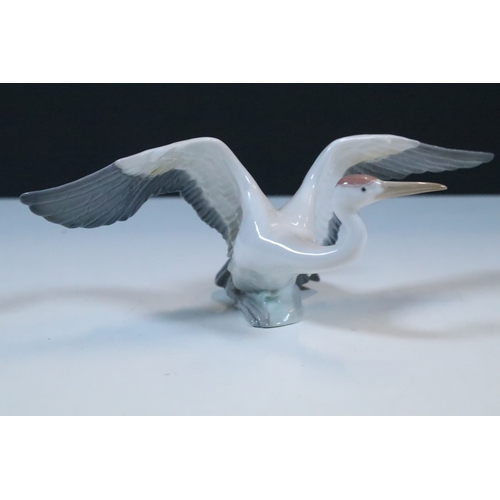 27 - Group of six Lladro and a Nao porcelain figurines to include rabbit, girl and dog, polar bear, cat, ... 