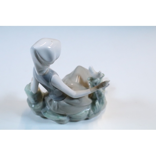 27 - Group of six Lladro and a Nao porcelain figurines to include rabbit, girl and dog, polar bear, cat, ... 