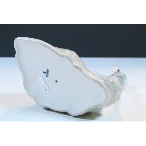 27 - Group of six Lladro and a Nao porcelain figurines to include rabbit, girl and dog, polar bear, cat, ... 