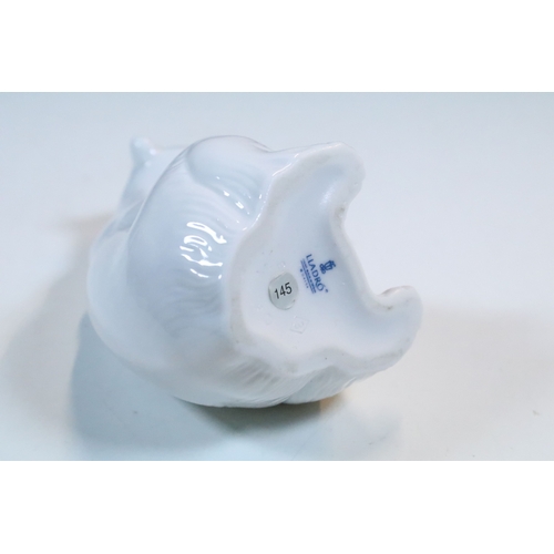 27 - Group of six Lladro and a Nao porcelain figurines to include rabbit, girl and dog, polar bear, cat, ... 