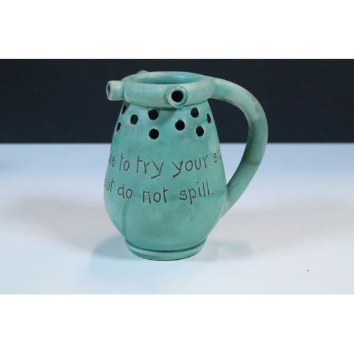 35 - Group of five Brannam Barum Barnstaple pottery pieces to include puzzle jugs, jug, vase and a grotes... 