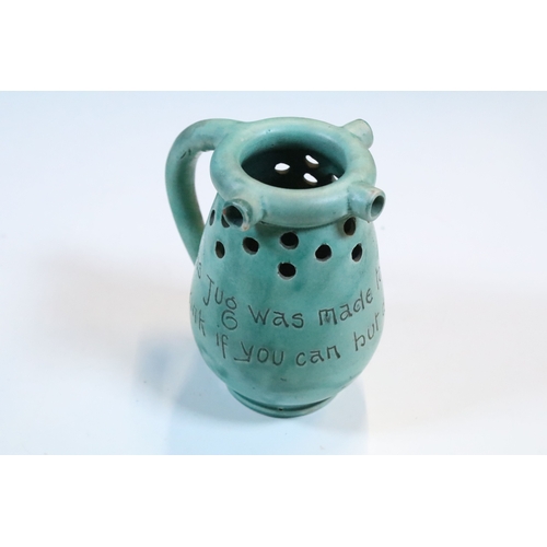 35 - Group of five Brannam Barum Barnstaple pottery pieces to include puzzle jugs, jug, vase and a grotes... 