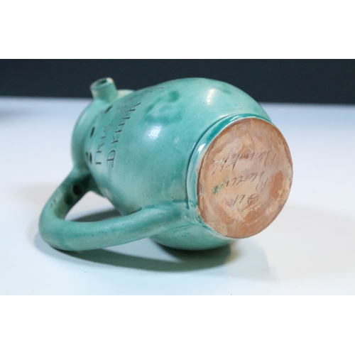 35 - Group of five Brannam Barum Barnstaple pottery pieces to include puzzle jugs, jug, vase and a grotes... 