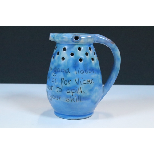 35 - Group of five Brannam Barum Barnstaple pottery pieces to include puzzle jugs, jug, vase and a grotes... 