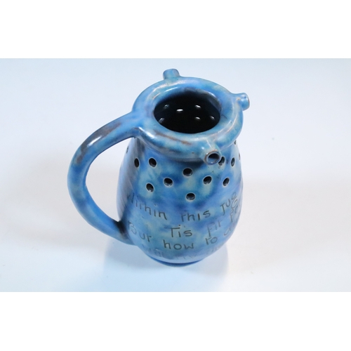 35 - Group of five Brannam Barum Barnstaple pottery pieces to include puzzle jugs, jug, vase and a grotes... 