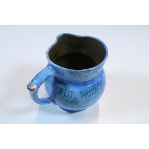 35 - Group of five Brannam Barum Barnstaple pottery pieces to include puzzle jugs, jug, vase and a grotes... 