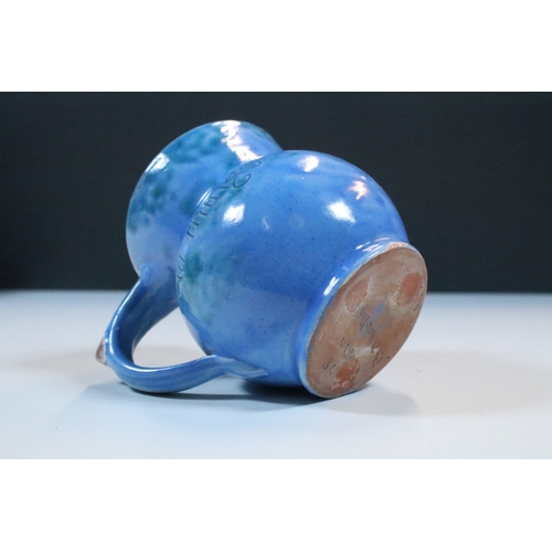 35 - Group of five Brannam Barum Barnstaple pottery pieces to include puzzle jugs, jug, vase and a grotes... 