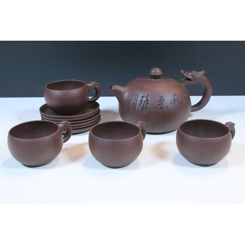 38 - Chinese Yixing terracotta part tea set, the teapot having dragon handle, having four tea cups and si... 