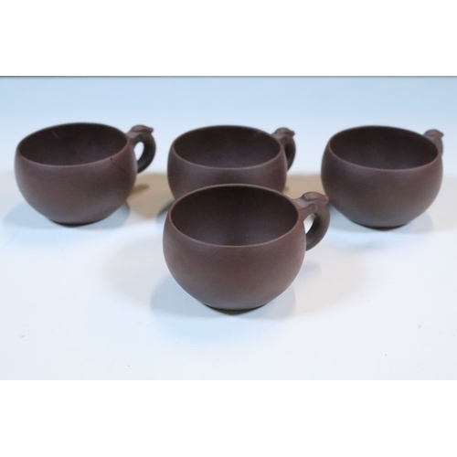 38 - Chinese Yixing terracotta part tea set, the teapot having dragon handle, having four tea cups and si... 
