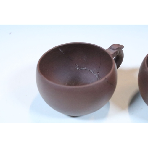 38 - Chinese Yixing terracotta part tea set, the teapot having dragon handle, having four tea cups and si... 