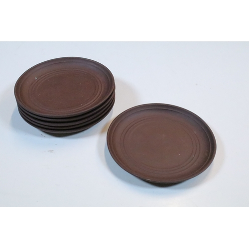 38 - Chinese Yixing terracotta part tea set, the teapot having dragon handle, having four tea cups and si... 