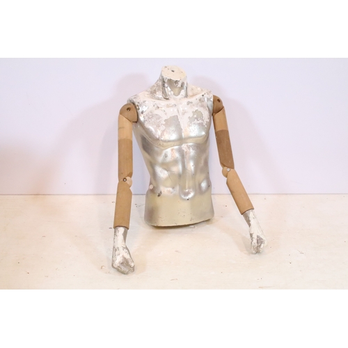 553 - Mid 20th century shop torso mannequin with wooden articulated arms, the body with a silvered and whi... 