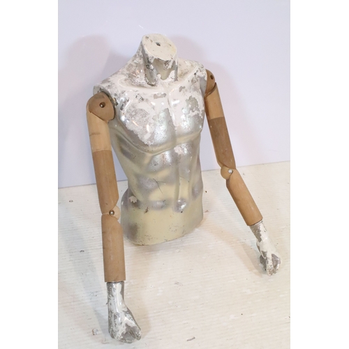 553 - Mid 20th century shop torso mannequin with wooden articulated arms, the body with a silvered and whi... 