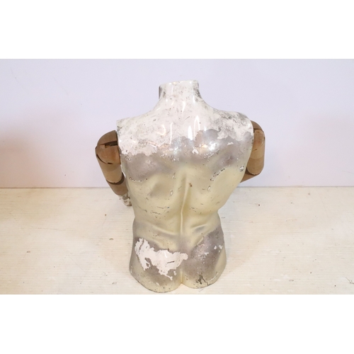 553 - Mid 20th century shop torso mannequin with wooden articulated arms, the body with a silvered and whi... 