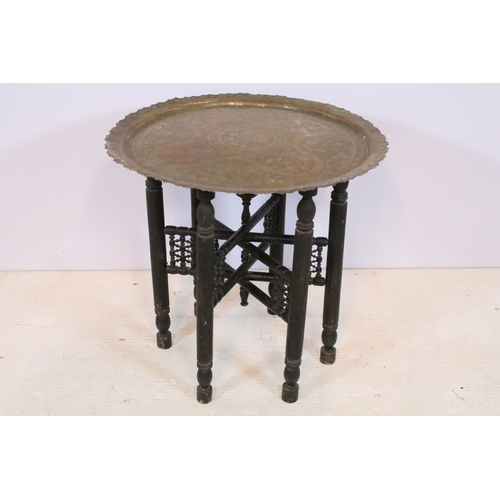 566 - Early 20th century brass topped Benares table, having tray top with incised and colour filled decora... 